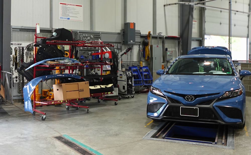 OEM Parts on left of blue car being repaired at b street collision center OEM Parts on left of blue car being repaired at b street collision center