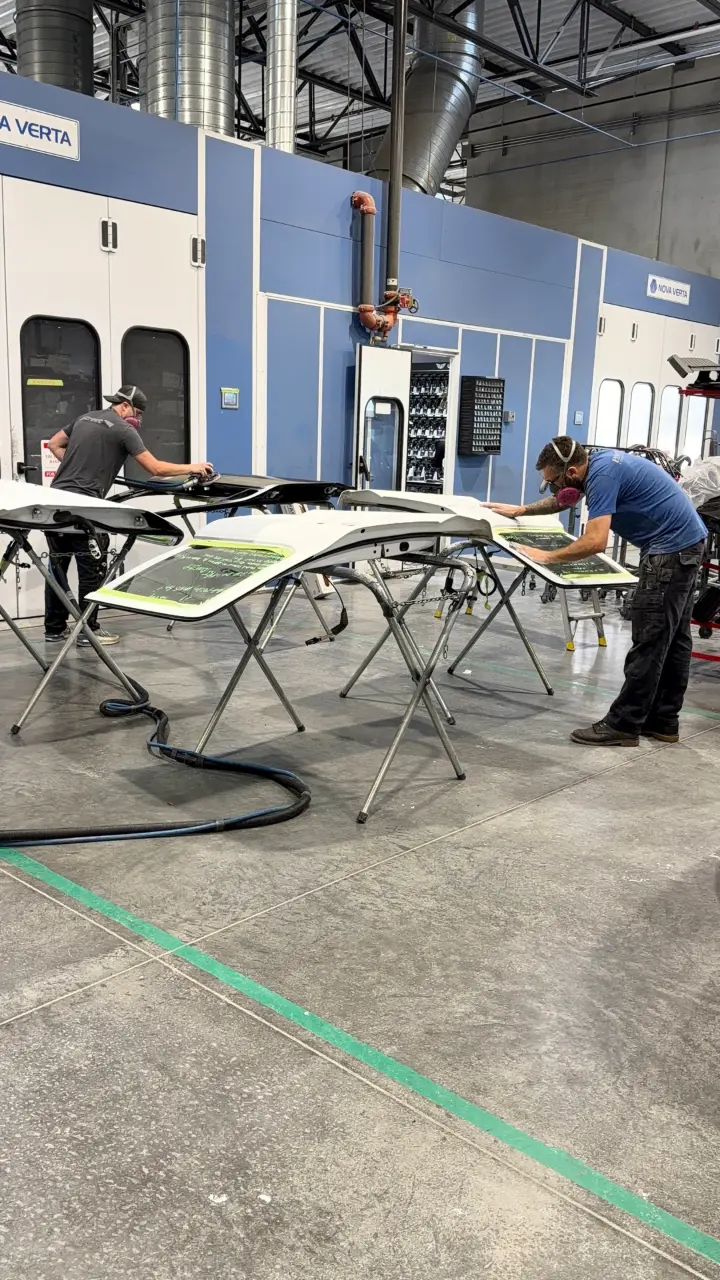 Technicians working on body panels in the aluminum repair room at B Street Collision Center