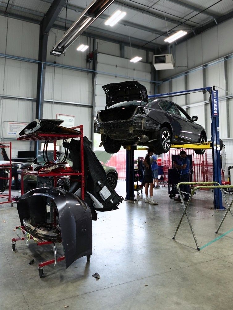 car on lift with oem parts sitting to the left inside B Street Collision Center car on lift with oem parts sitting to the left inside B Street Collision Center