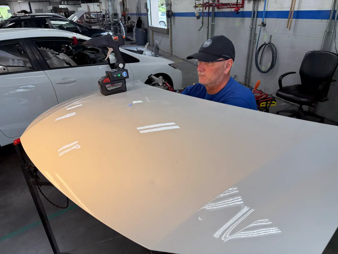 Hail Repair – Paintless Dent Repair at B Street Collision Center B Street Collision Center technician working on a panel for paintless hail dent repair